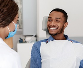 Man smiles at his K Street prosthodontist before treating cavities