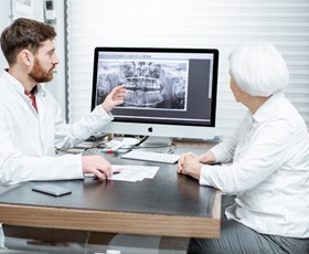 dentist showing a patient their X-rays 