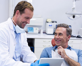 Dentist reviewing oral exam results with patient