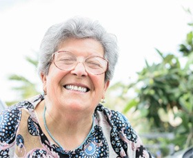 a woman in Washington smiling with her dentures