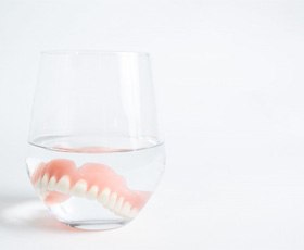 an example of a denture in a glass of water