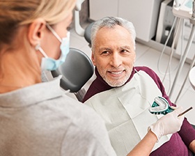 A dentist assessing a man for dentures