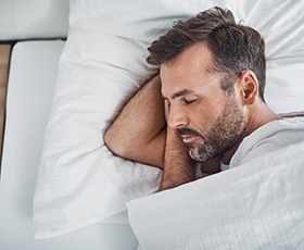 Man resting after dental implant surgery in Washington, DC