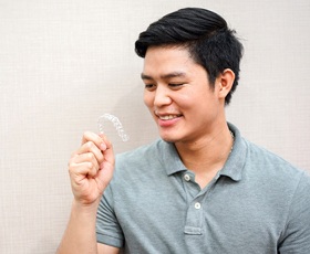 Man looking at clear aligner