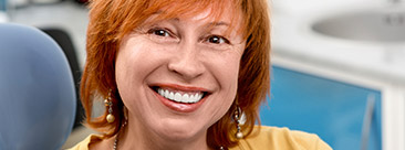 Smiling senior woman in dental chair