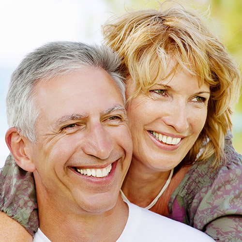 Smiling older man and woman outdoors