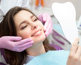 woman smiling in dental mirror  