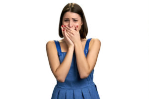 upset woman covering mouth