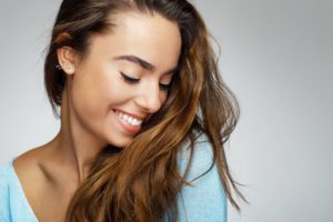 a young woman with white teeth