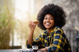 person eating a cookie and smiling