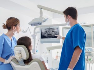 dentist on K Street showing patient her dental x-rays 