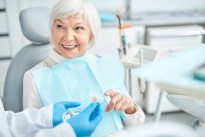 older woman asks about dental bridge lifespan