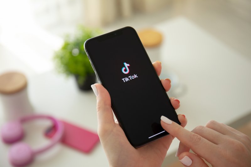 woman scrolling through TikTok on phone